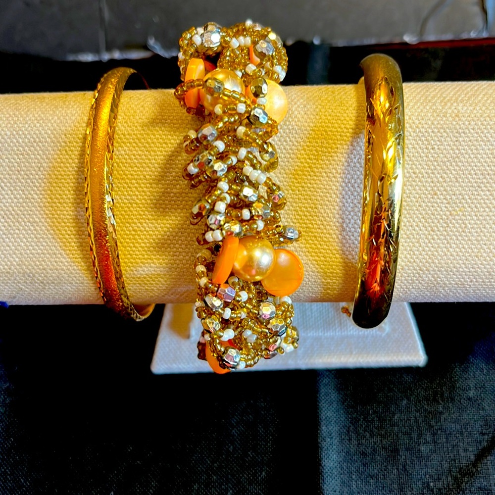 Set of 3 gold tone costume jewlery. Beaded is stretch and wide gold tone opens.